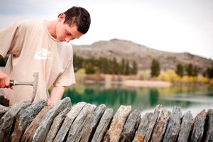Nikora Parsons works on a wall in old Cromwell last week. (picture by: Isabella Harrex)